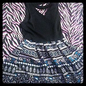 A beautiful dress with flowers on it. There is a b